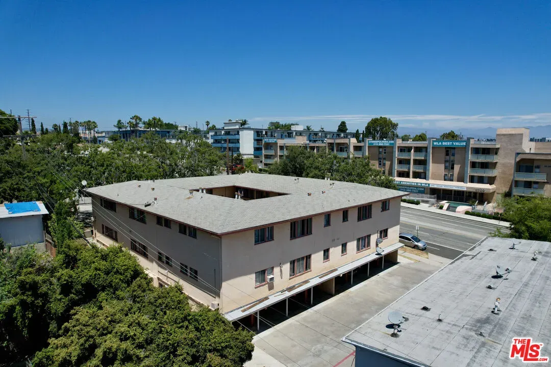a view of a white building in front of a house