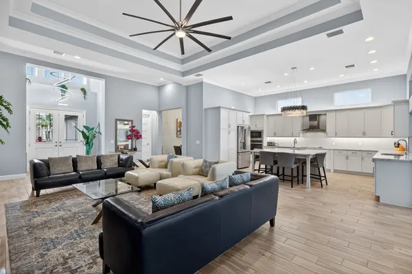 a living room with furniture and kitchen view