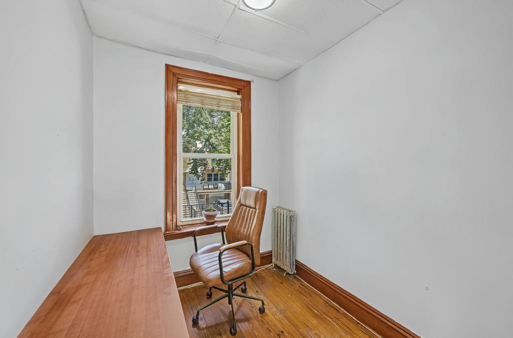 10 Seeley Street Brooklyn, NY 11218 - Photo 16 of 27 a workspace with wooden floor and a window
