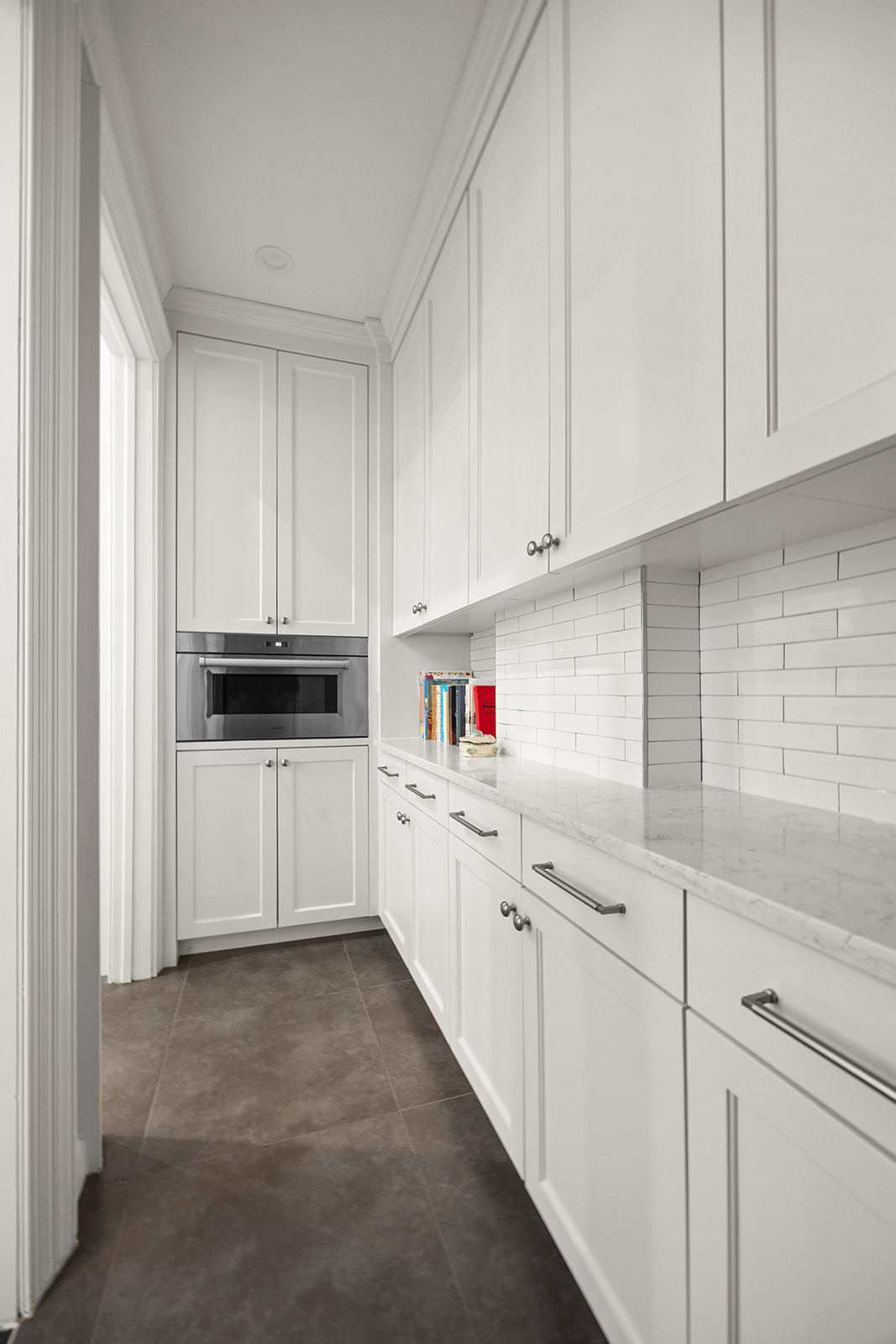 895 West End Avenue, Unit 1B Manhattan, NY 10025 - Photo 8 of 23 a kitchen with white cabinets and white appliances