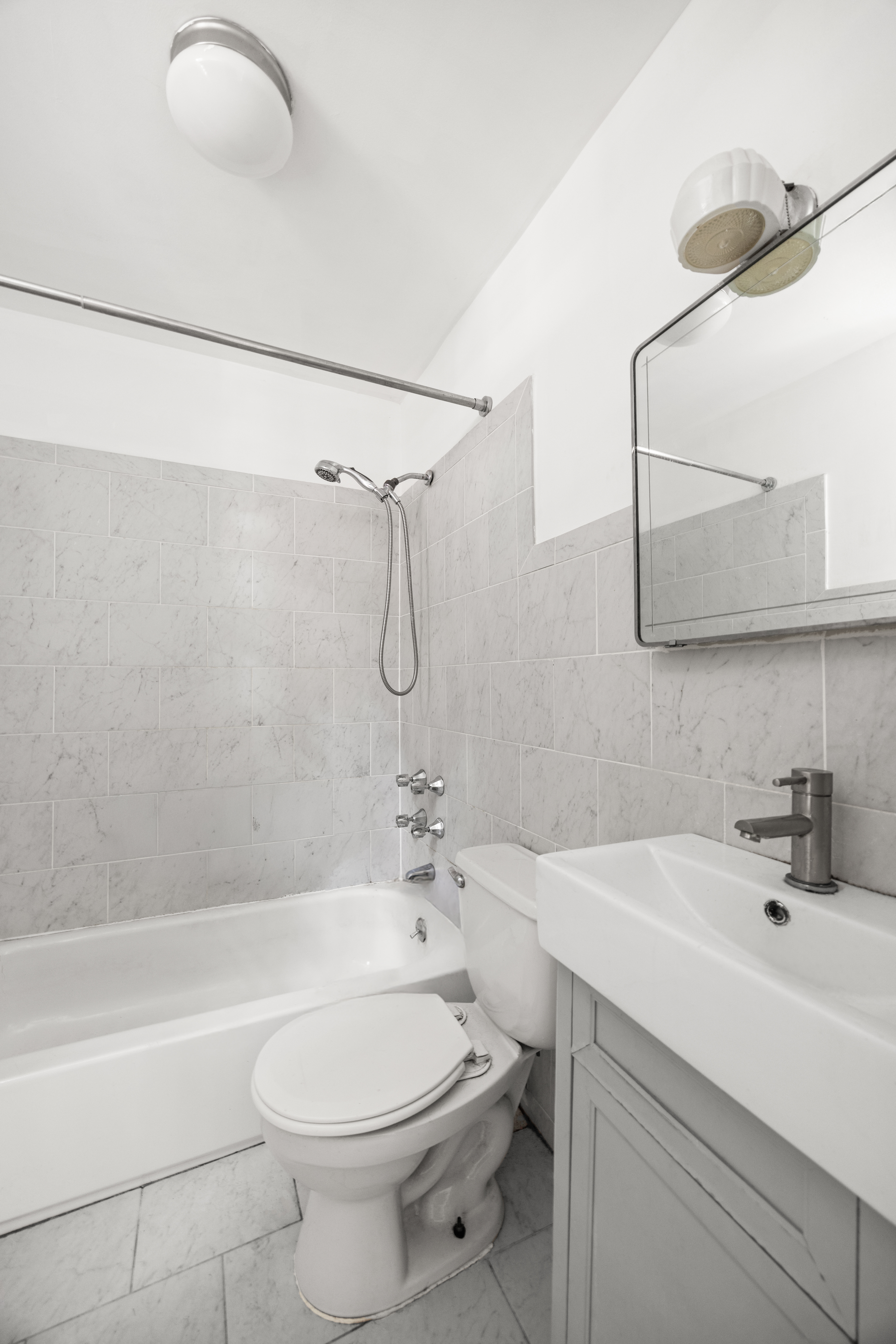 215 Stratford Road, Unit 1 Brooklyn, NY 11218 - Photo 7 of 9 a bathroom with a sink a toilet and shower