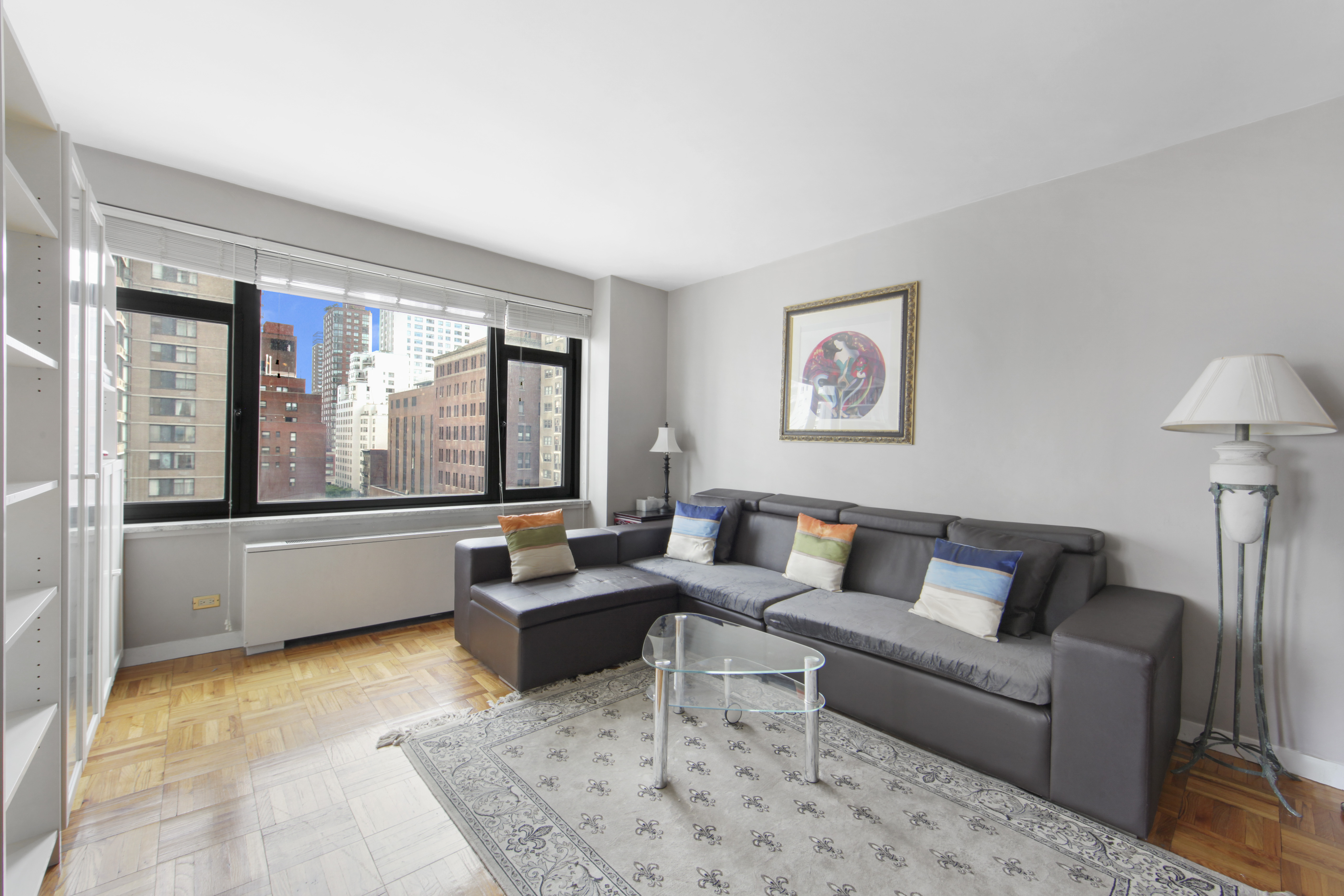 160 East 65th Street, Unit 8A Manhattan, NY 10065 - Photo 6 of 13 a living room with furniture and a large window