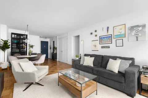 a living room with furniture and kitchen view