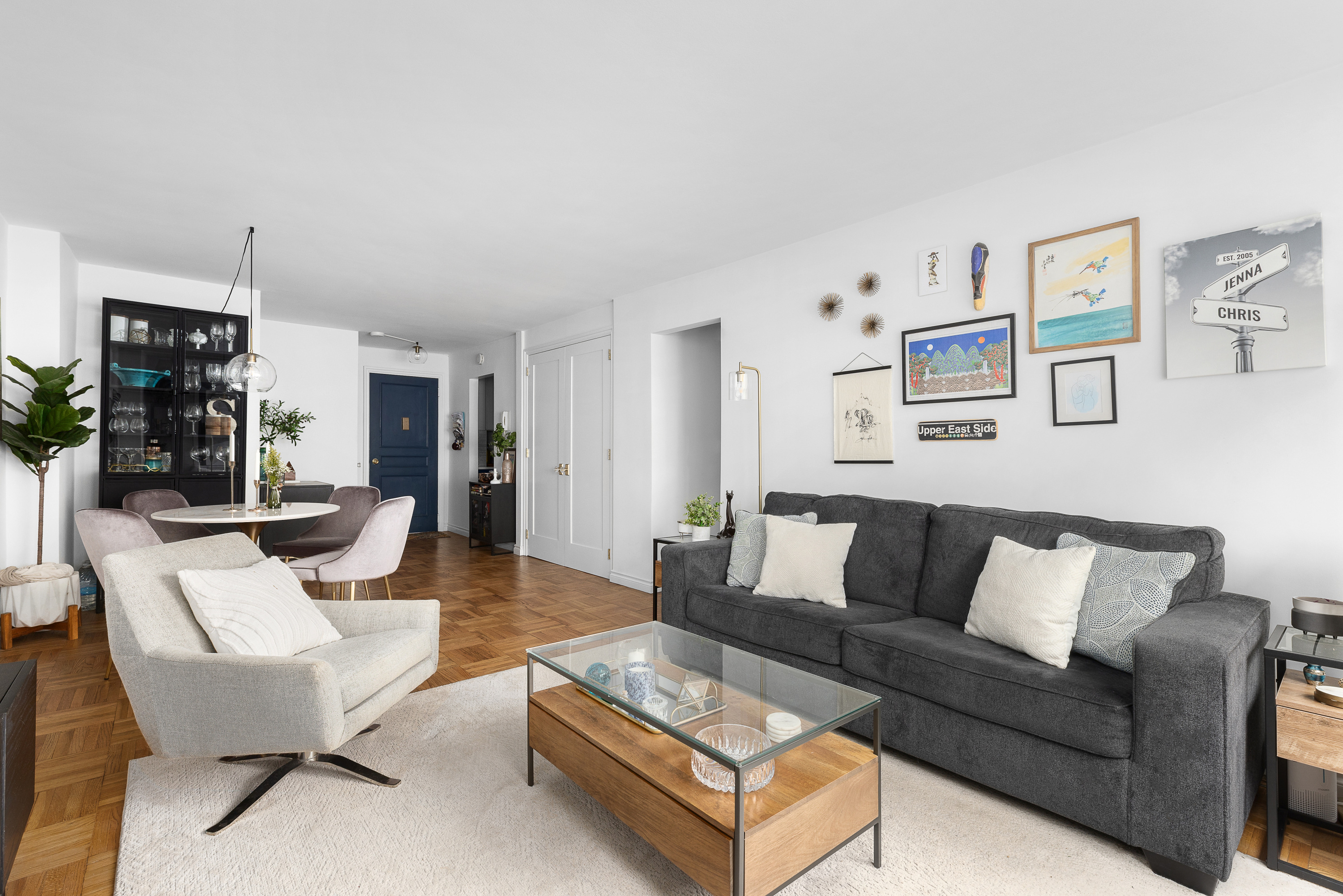 333 East 66th Street, Unit 8C Manhattan, NY 10065 - Photo 4 of 13 a living room with furniture and kitchen view