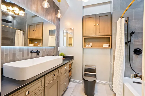 a bathroom with a sink a toilet and shower
