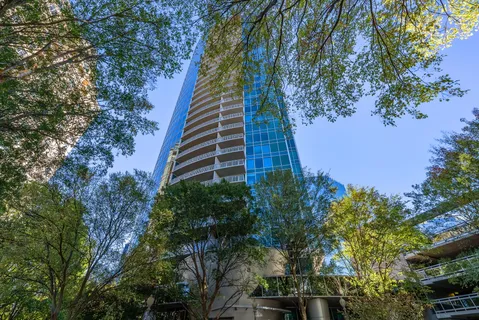 a view of kitchen with stainless steel appliances wooden floor and a window