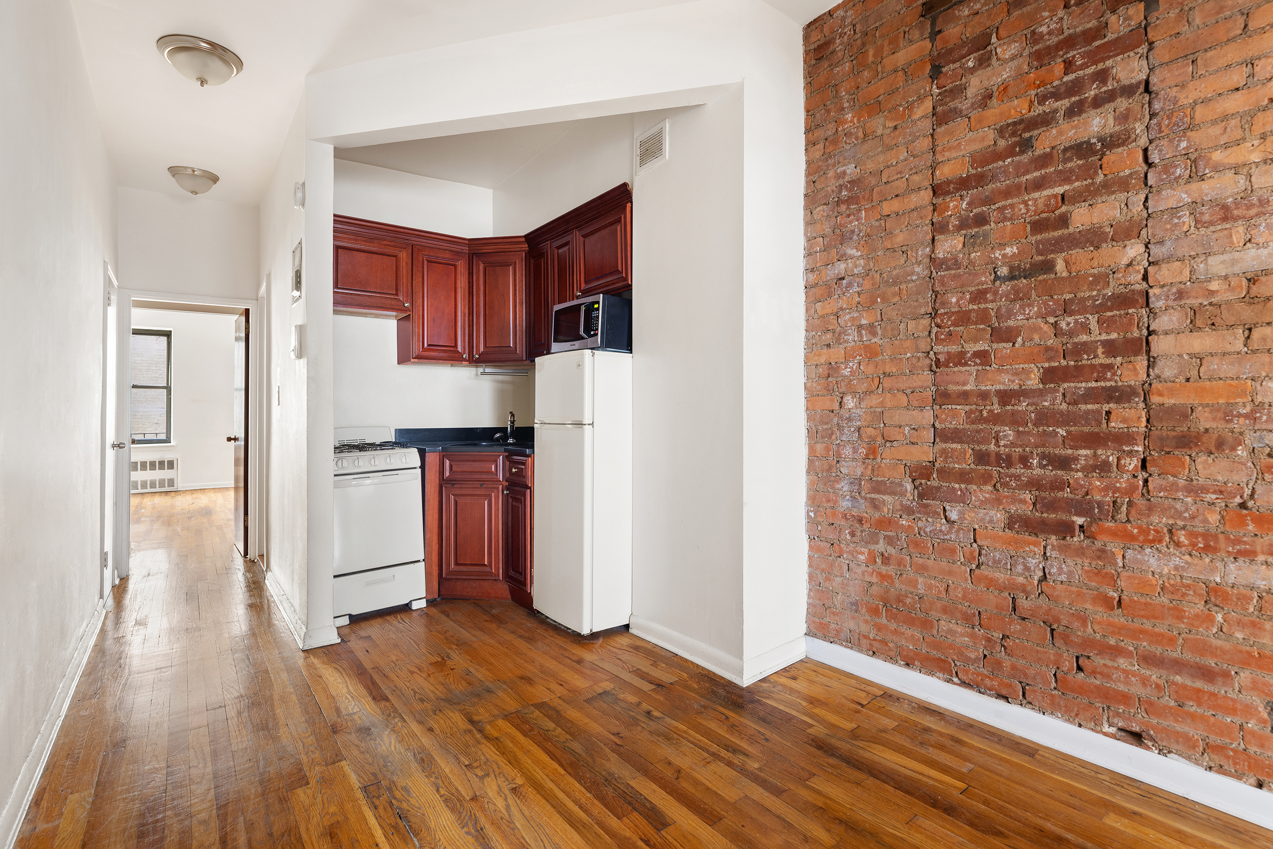 1275 3rd Avenue, Unit 4A Manhattan, NY 10021 - Photo 4 of 8 a view of kitchen with wooden floor
