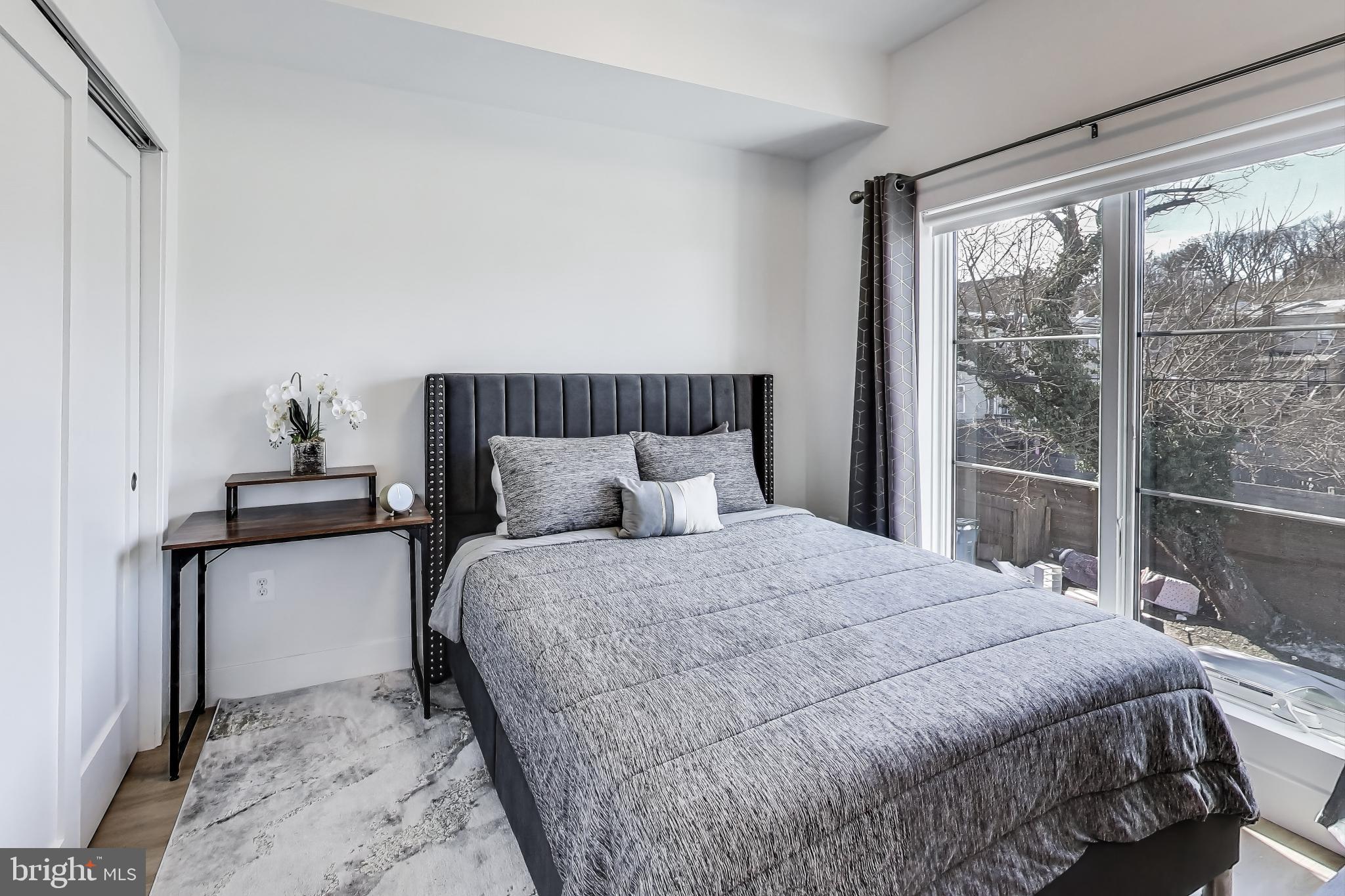 2310 4th Street Northeast, Unit 15 Washington, DC 20002 - Photo 9 of 21 a bedroom with a bed and window