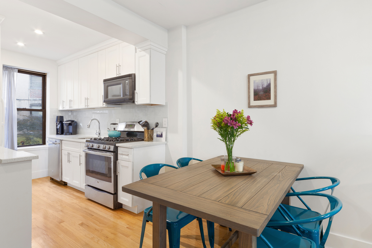 2116 Dorchester Road, Unit 1I Brooklyn, NY 11226 - Photo 14 of 15 a kitchen with a table and chairs in it