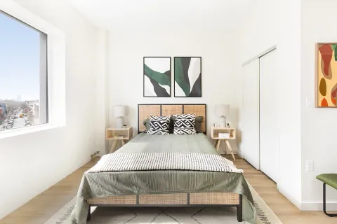 a bedroom with a bed and a window