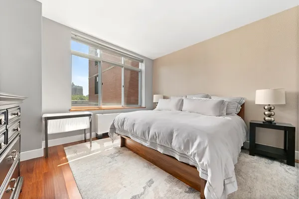 a bedroom with a bed and a night stand