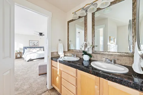 a en suite bathroom with double sink and a mirror