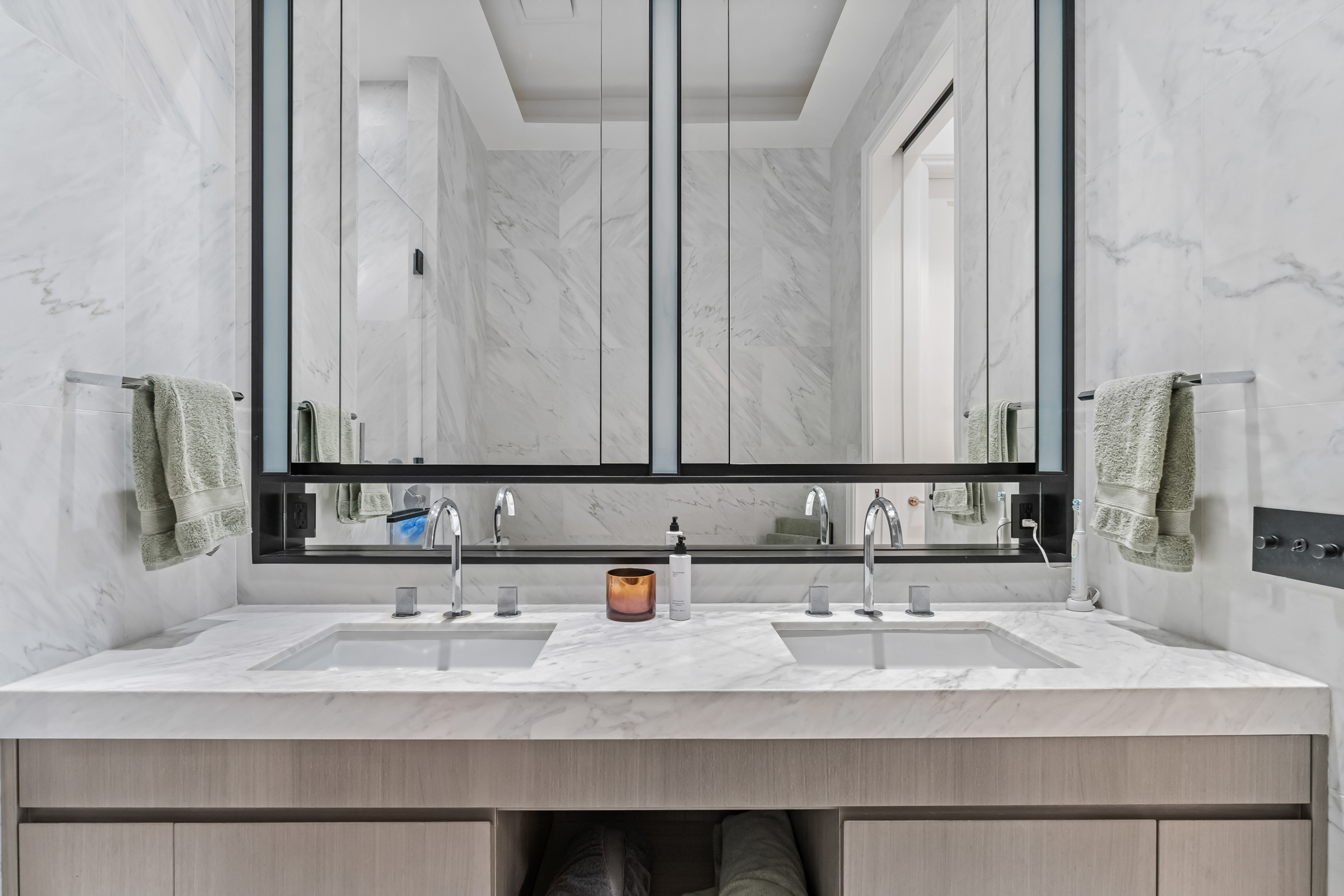 108 Leonard Street, Unit 4K Manhattan, NY 10013 - Photo 9 of 11 a bathroom with double vanity sinks and a mirror
