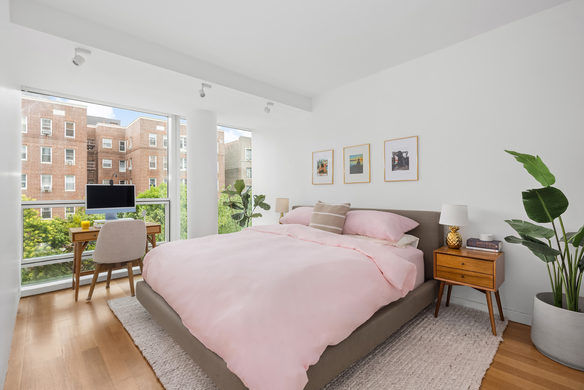 1 Grand Army Plaza, Unit 3C Brooklyn, NY 11238 - Photo 8 of 23 a bedroom with a bed a table and a potted plant