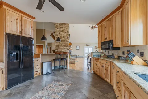 a kitchen with a sink appliances cabinets and furniture