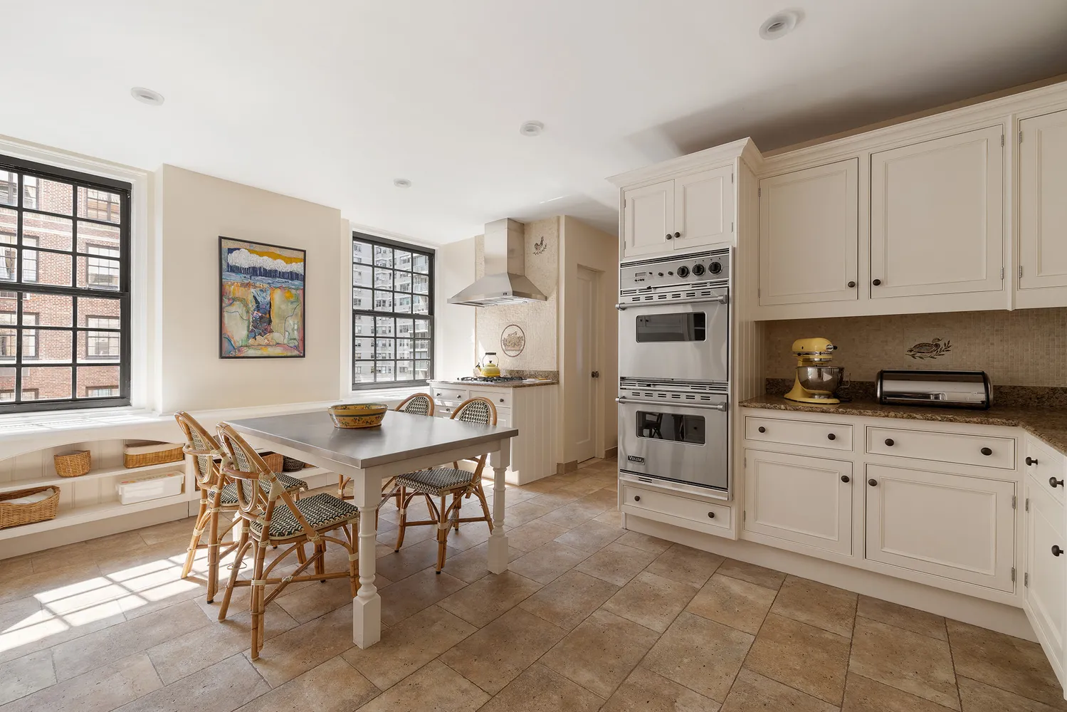 a kitchen with stainless steel appliances granite countertop a stove and white cabinets