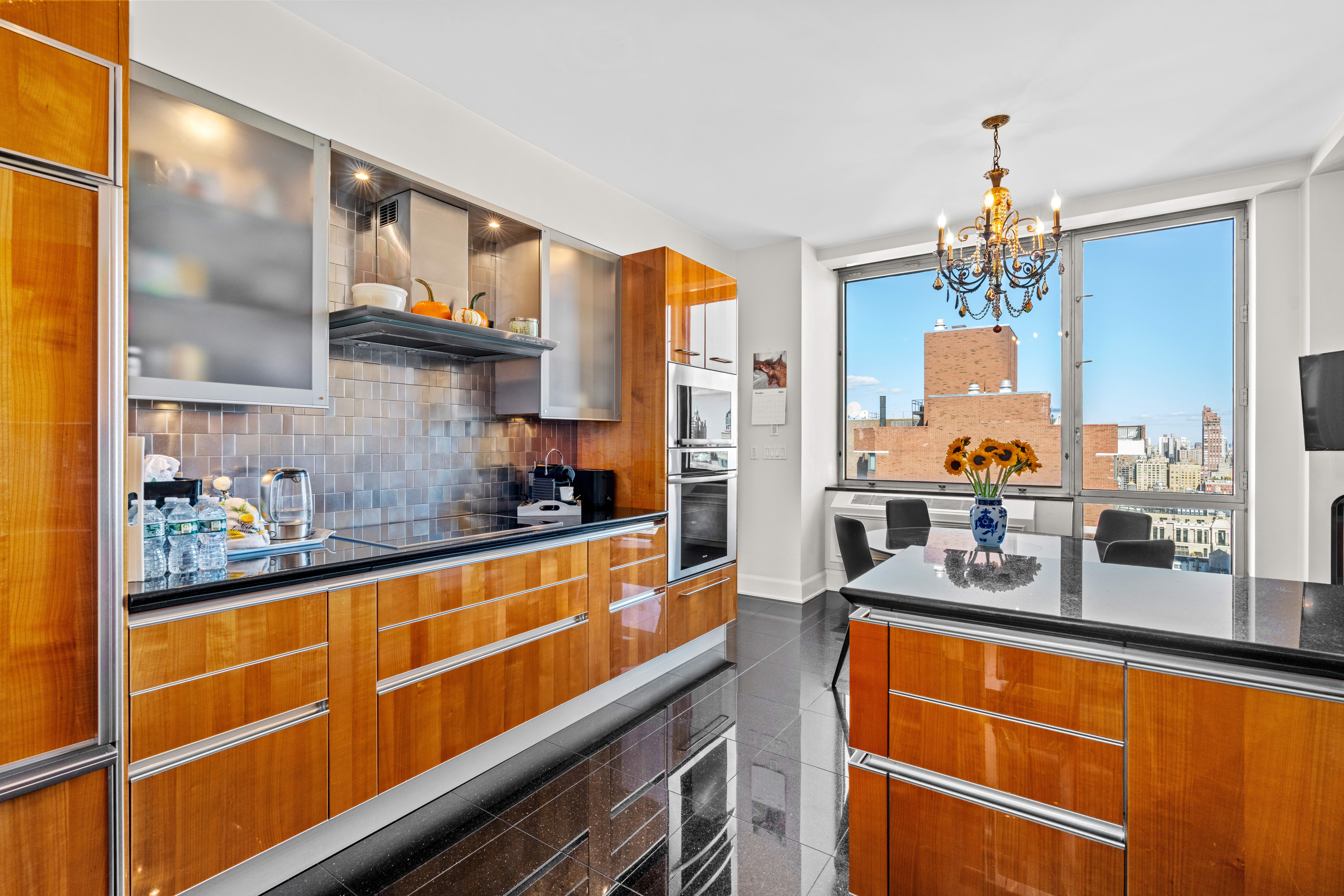 1965 Broadway, Unit 26EF Manhattan, NY 10023 - Photo 9 of 32 a kitchen with granite countertop stainless steel appliances and counter space