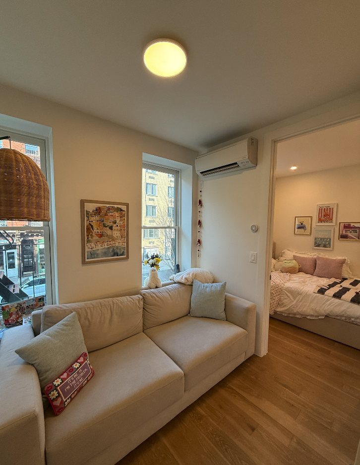 34 Carmine Street, Unit 2D Manhattan, NY 10014 - Photo 3 of 8 a living room with furniture and a large window