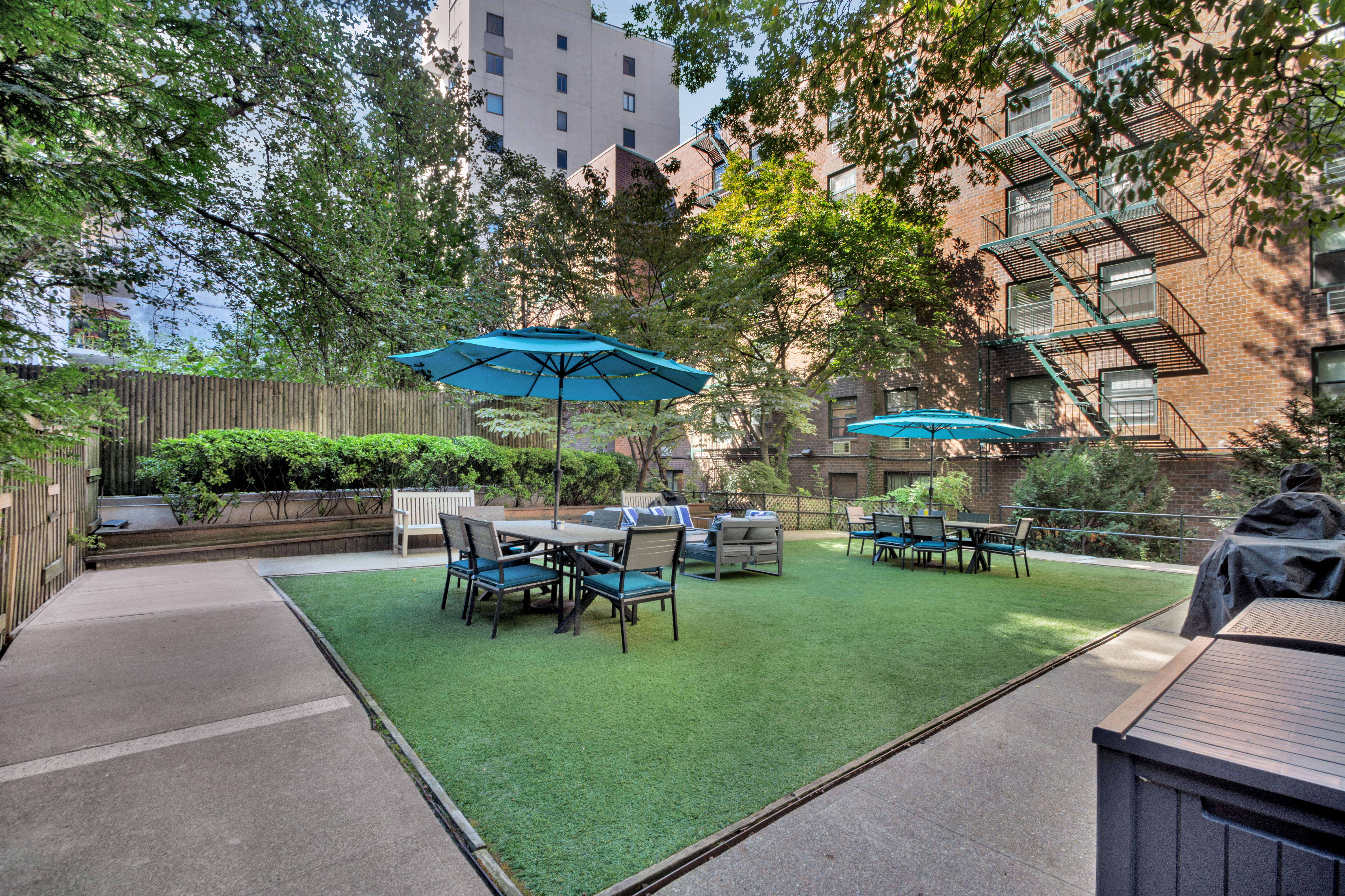 690 Washington Street, Unit 1A Manhattan, NY 10014 - Photo 15 of 17 a view of a table and chairs under an umbrella