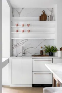 a sink with white cabinets