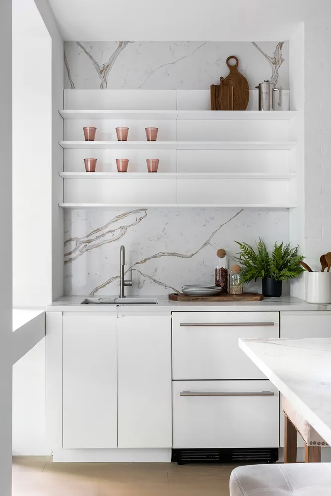 a sink with white cabinets