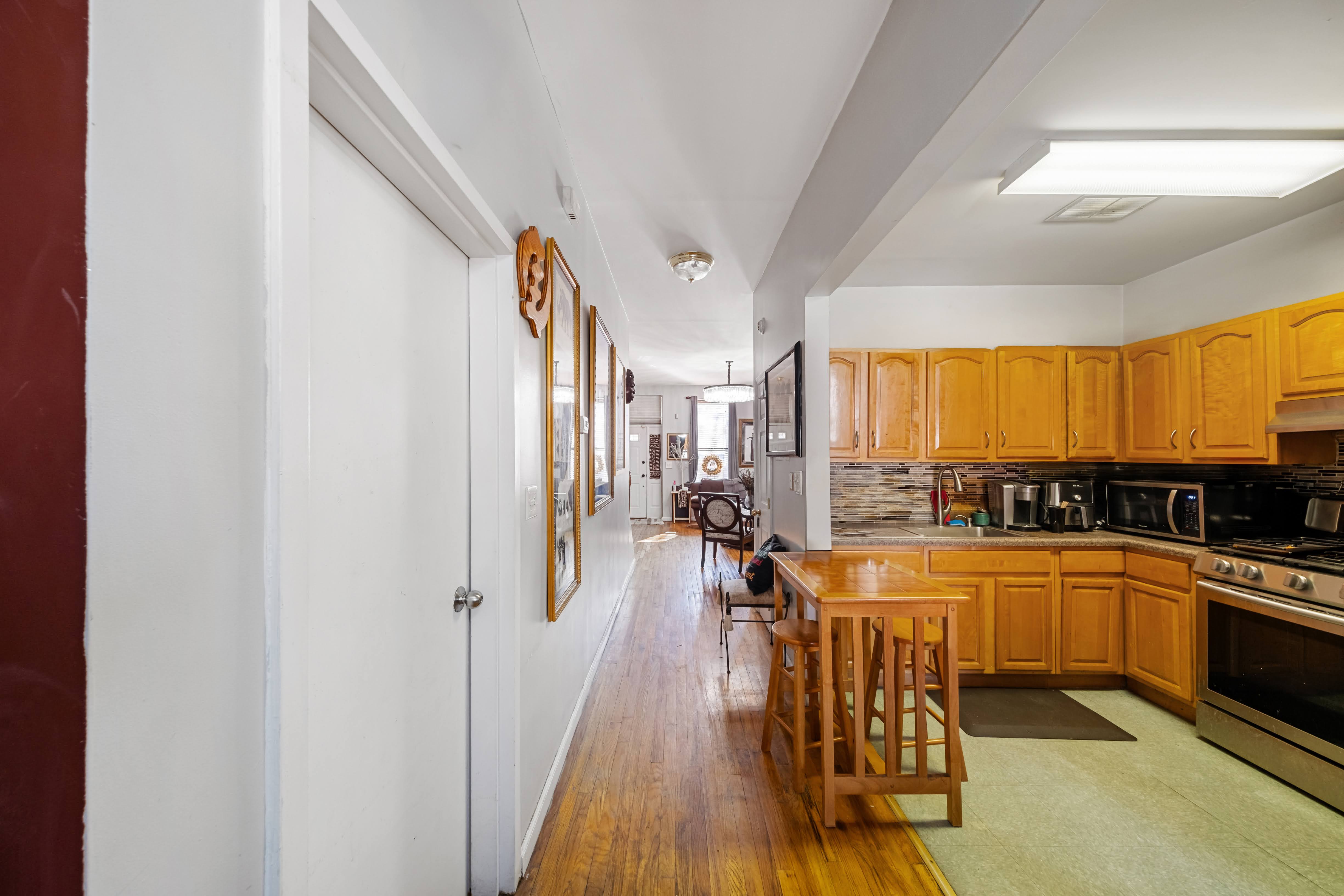 275 Van Buren Street Brooklyn, NY 11221 - Photo 7 of 33 a view of a kitchen with a sink and cabinets