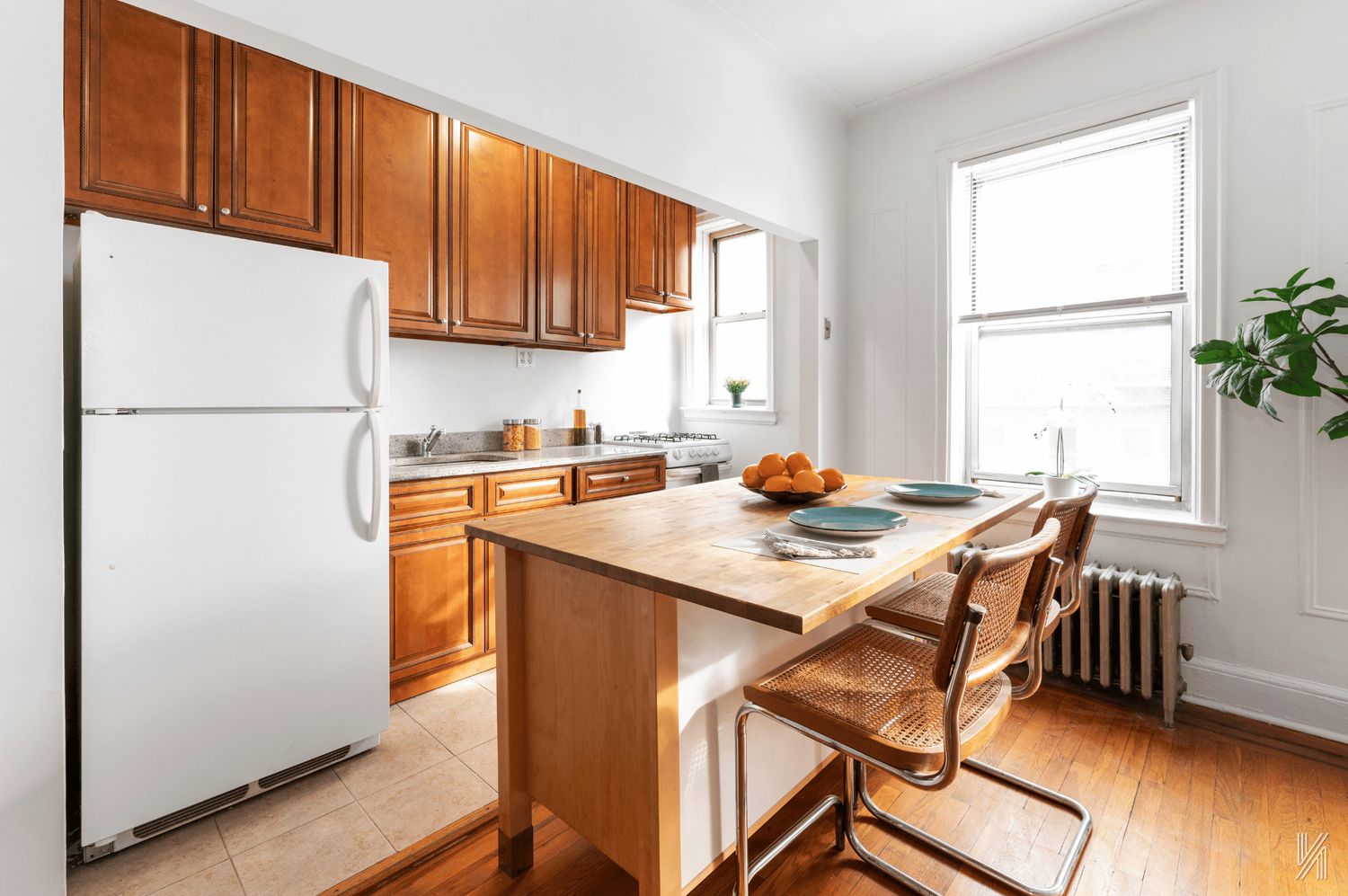 59-11 Queens Boulevard, Unit 3J Queens, NY 11377 - Photo 4 of 18 a kitchen with stainless steel appliances granite countertop a refrigerator a sink a stove and white cabinets with wooden floor