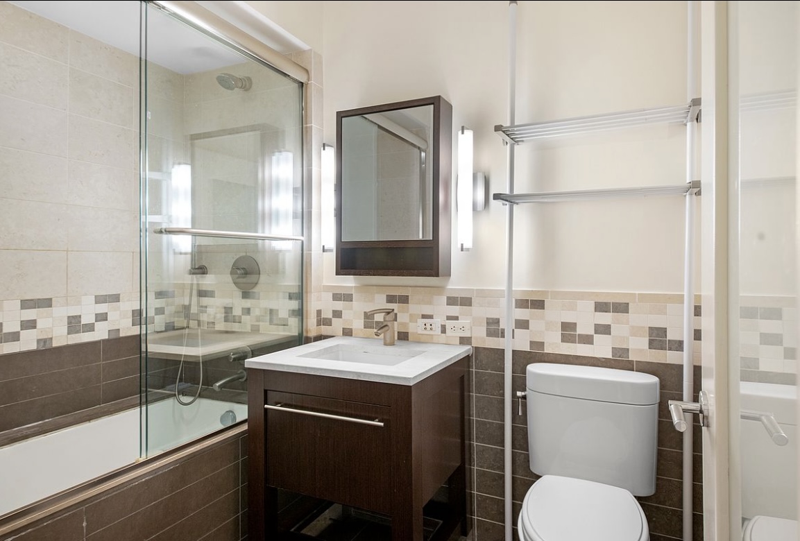 101 West 24th Street, Unit 7A Manhattan, NY 10011 - Photo 9 of 13 a bathroom with a sink and a mirror