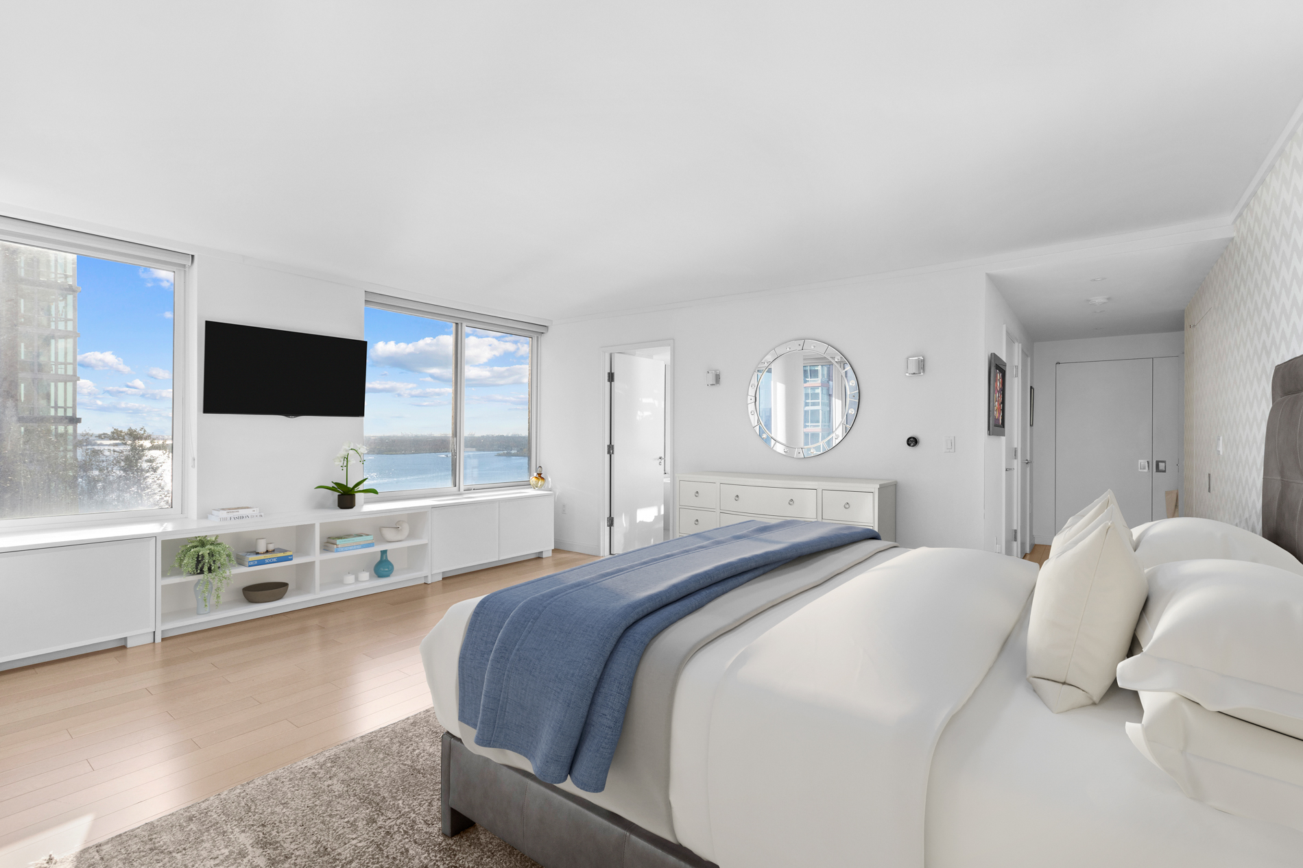 212 Warren Street, Unit 20A Manhattan, NY 10282 - Photo 10 of 23 a bedroom with a bed and a flat screen tv