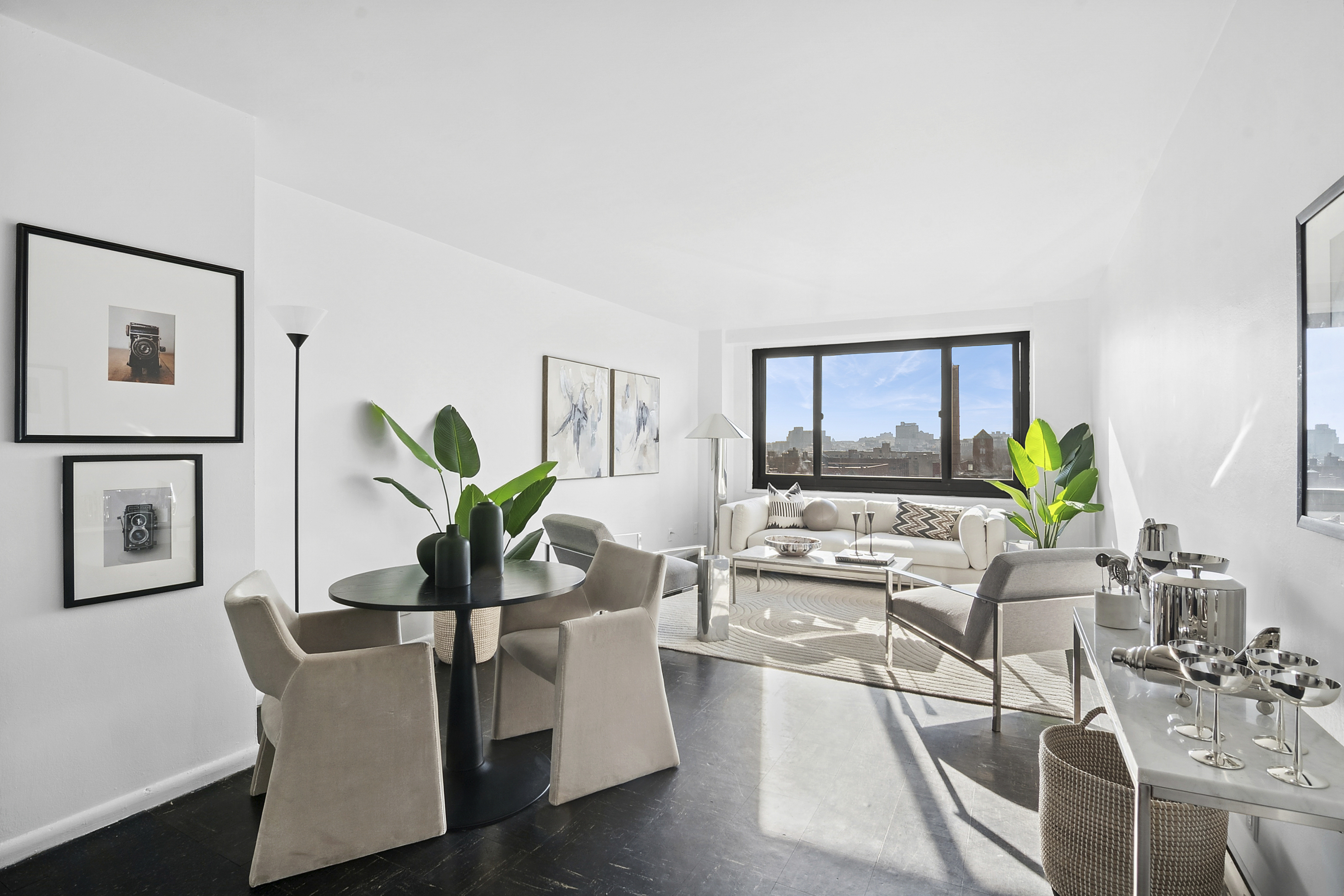 195 Willoughby Avenue, Unit 1206 Brooklyn, NY 11205 - Photo 2 of 10 a living room with furniture potted plant and a large window