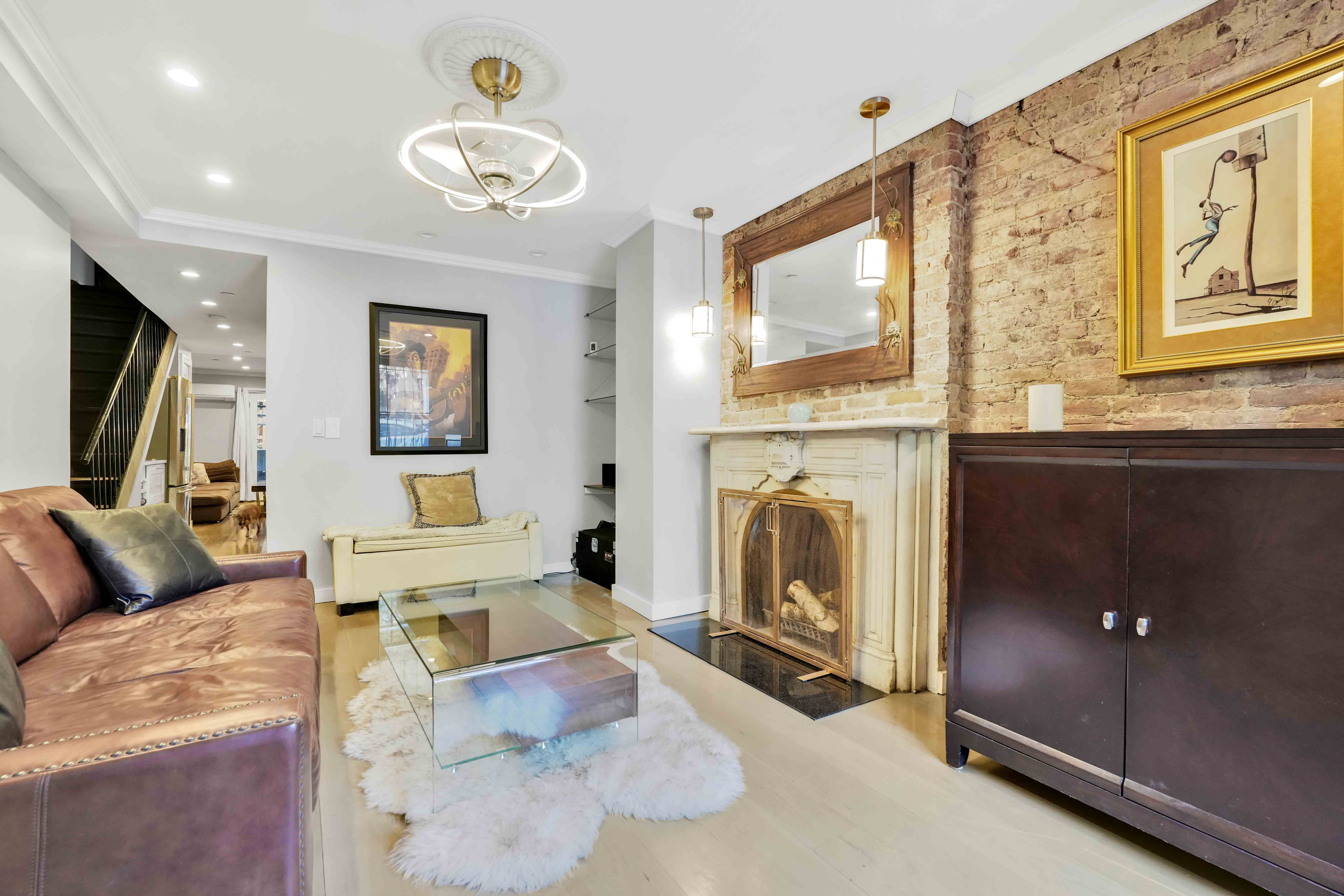 288 St James Place, Unit TRIPLEX Brooklyn, NY 11238 - Photo 11 of 25 a living room with furniture a fireplace and a flat screen tv
