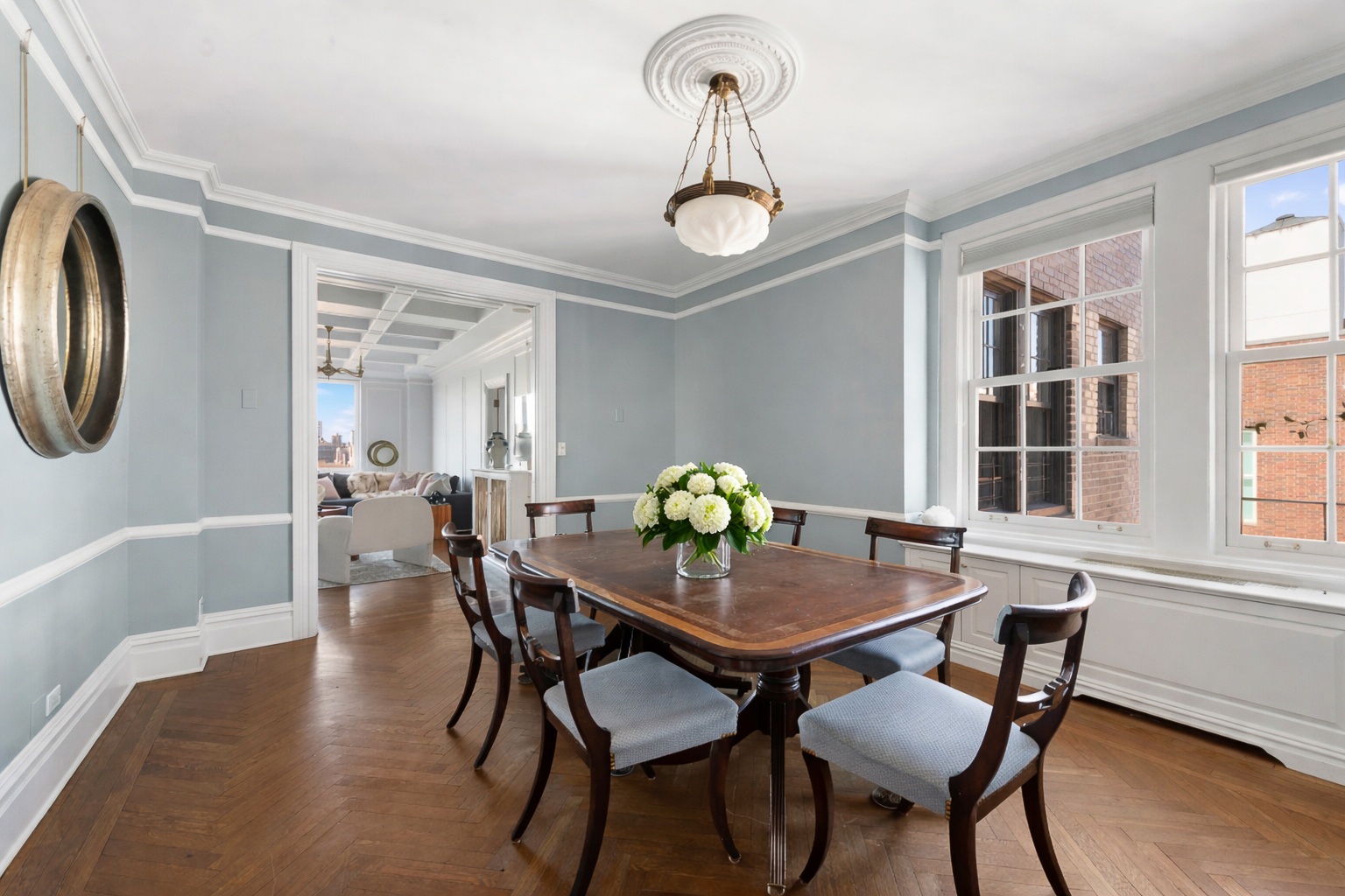 1140 5th Avenue, Unit 14B Manhattan, NY 10128 - Photo 4 of 18 a view of a dining room with furniture window and wooden floor
