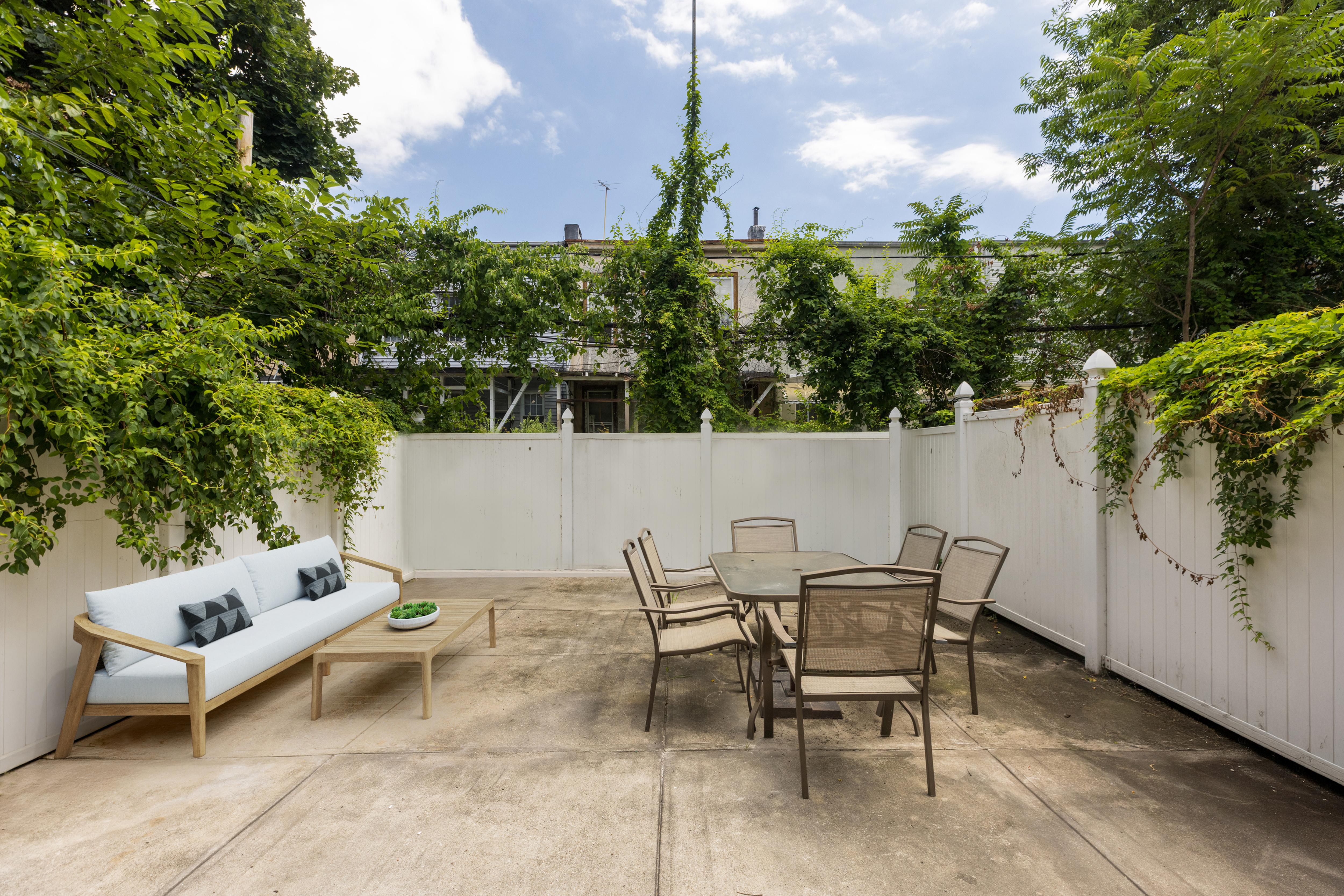 1068 Hancock Street, Unit 1 Brooklyn, NY 11221 - Photo 2 of 11 a backyard of a house with table and chairs