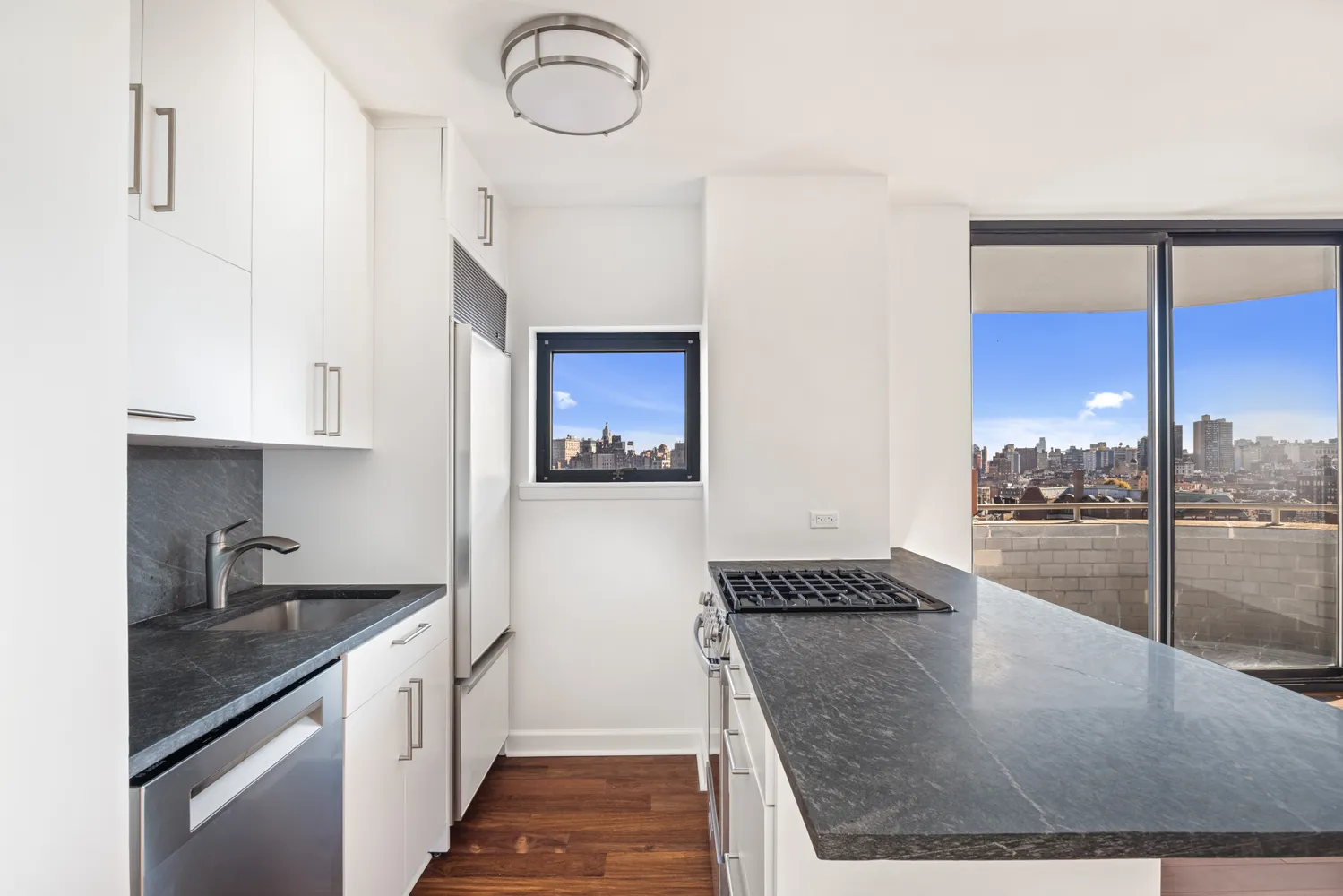 a kitchen with stainless steel appliances granite countertop a sink a stove top oven a counter space and cabinets