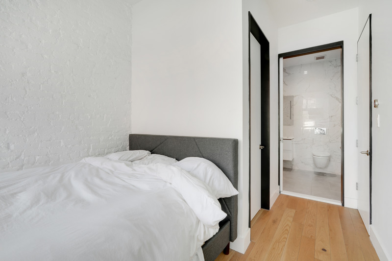 100 2nd Avenue, Unit 2 Manhattan, NY 10003 - Photo 8 of 10 a large white bed in a room next to a bedroom