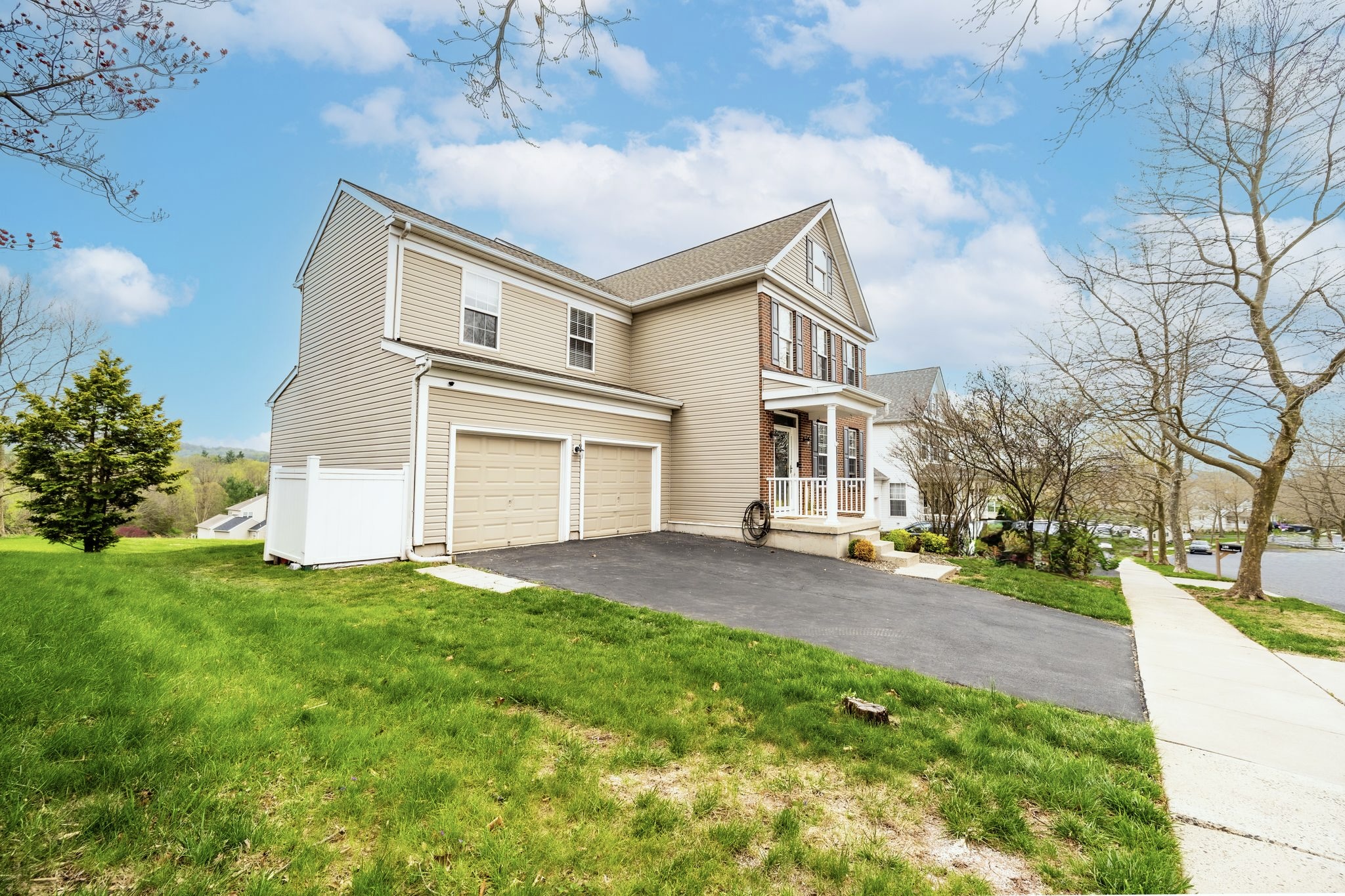 127 Hartman Road Pottstown, PA 19465 - Photo 2 of 42 a front view of a house with a garden and yard