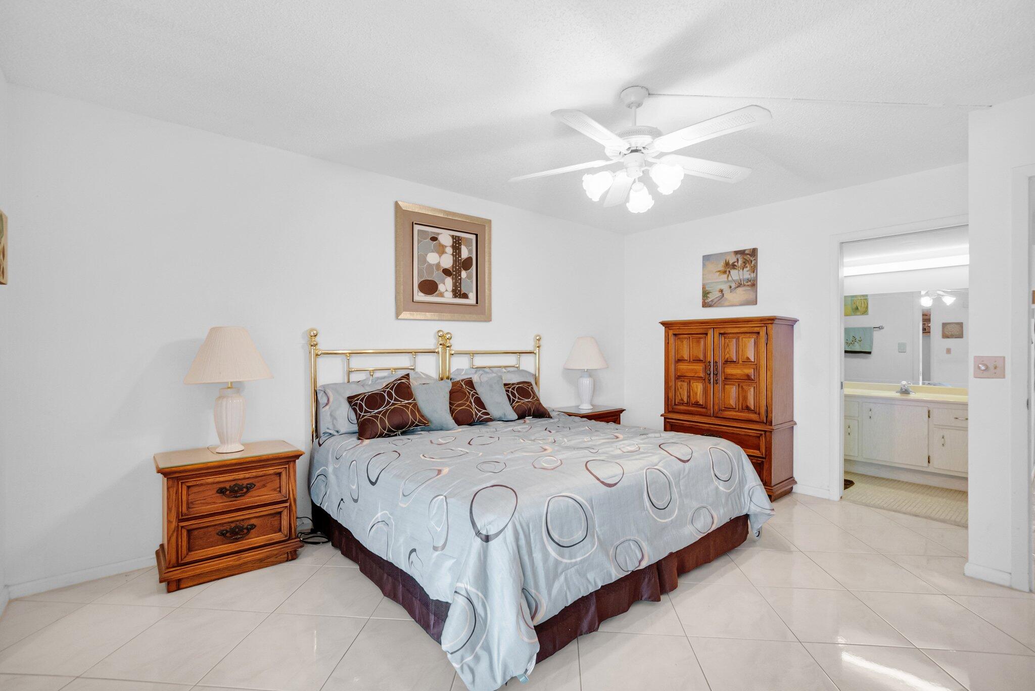 2035 Ainslie C Boca Raton, FL 33434 - Photo 6 of 17 a bedroom with a bed and a chandelier