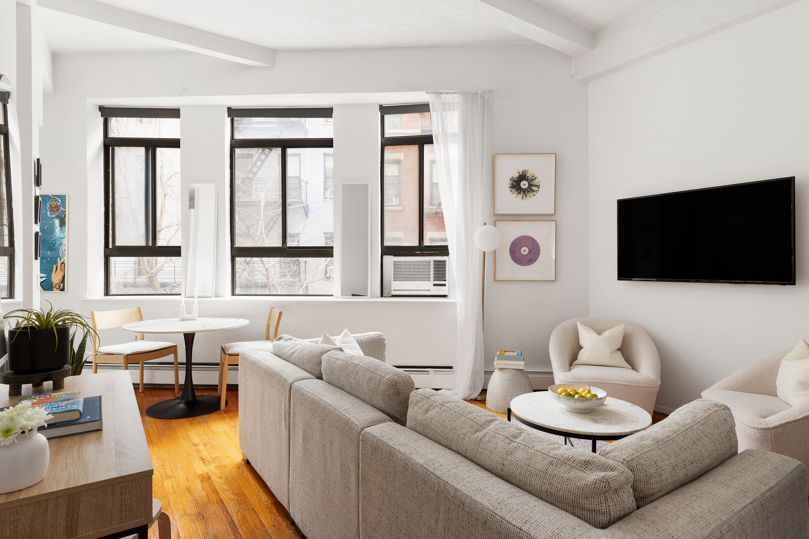 2 Cornelia Street, Unit 201 Manhattan, NY 10014 - Photo 1 of 11 a living room with furniture and a flat screen tv