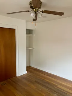 a view of a room with wooden floor and cabinet