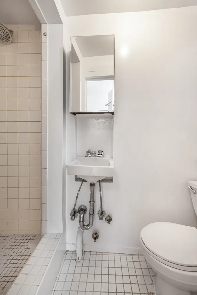 a bathroom with a sink toilet and a mirror