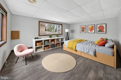 a bedroom with two beds and a chandelier