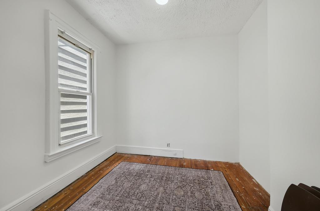 10 Seeley Street Brooklyn, NY 11218 - Photo 23 of 27 a view of room with window and carpet