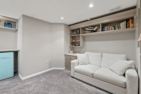 a living room with a couch and a book shelf