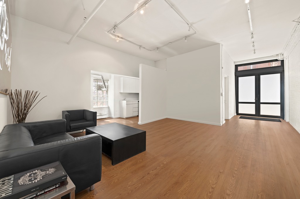 13 Worth Street, Unit 11 Manhattan, NY 10013 - Photo 8 of 9 a living room with furniture and a window