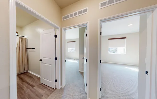 a bathroom with a toilet a sink a mirror and shower