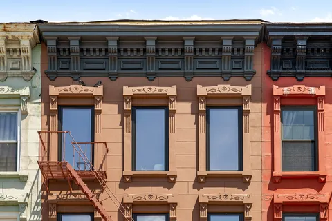 a view of a brick building with many windows