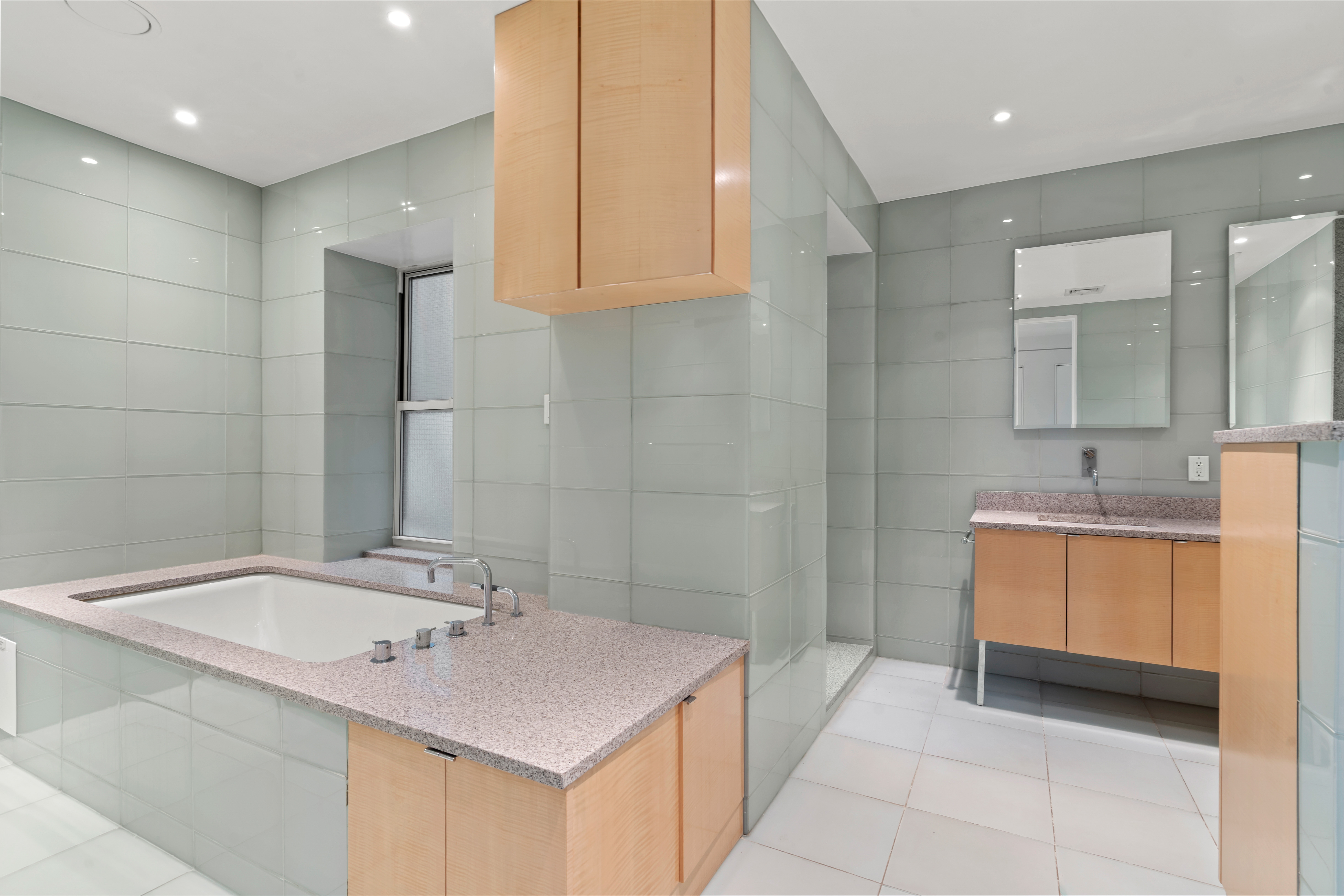 32 Laight Street, Unit 5 Manhattan, NY 10013 - Photo 21 of 31 a bathroom with a tub sink and mirror