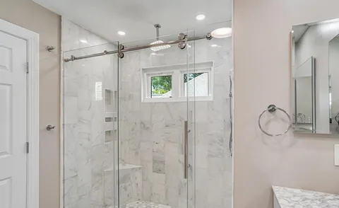 a bathroom with a shower sink and mirror