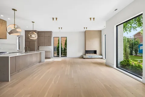 a large kitchen with kitchen island a large counter space a sink appliances and cabinets