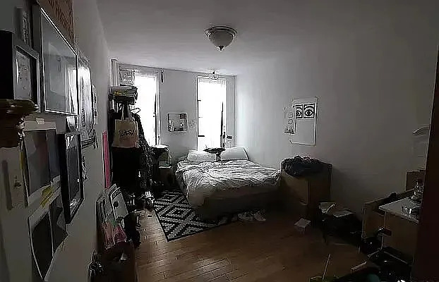 402 East 69th Street, Unit 23 Manhattan, NY 10065 - Photo 5 of 6 a bedroom with a bed and wooden floor